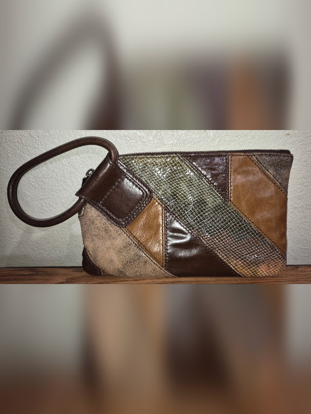 Hobo The Original Sable leather wristlet featuring a patchwork design in brown